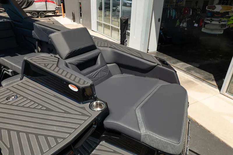 Slide: The Image of 2026 MasterCraft XStar 25 boat interior with sleek, modern seating and cup holder. - 19