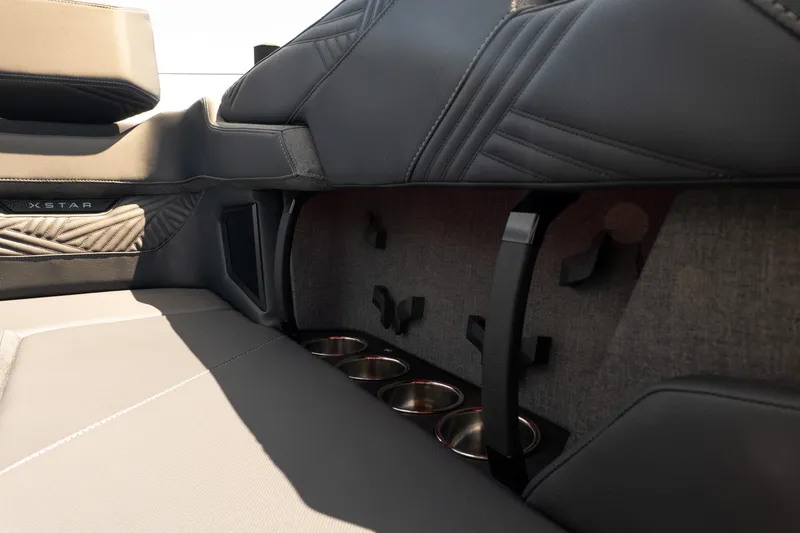 Slide: The Image of 2026 MasterCraft XStar 25 interior with cup holders and sleek seating design. - 25