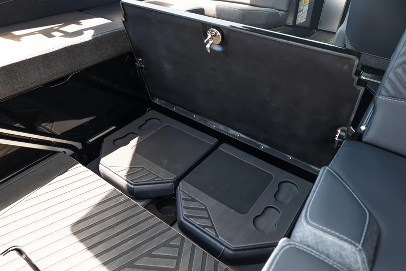 Slide: The Image of Storage compartment in 2026 MasterCraft XStar 25 boat, featuring secure lock and ample space. - 29