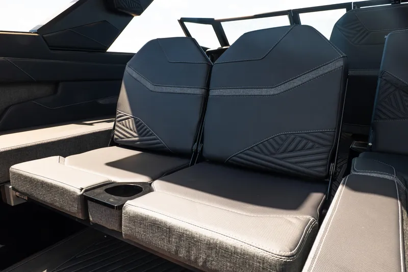Slide: The Image of 2026 MasterCraft XStar 25 interior seating with modern design and cup holder. - 31