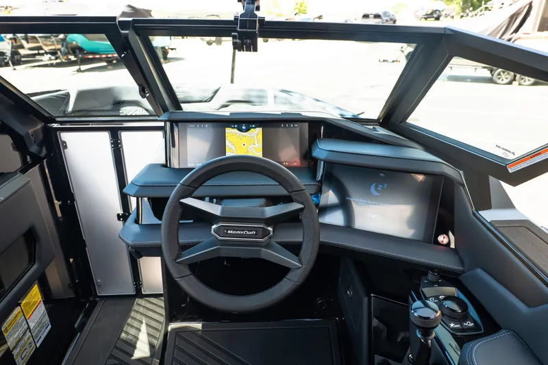 Slide: The Image of 2026 MasterCraft XStar 25 boat dashboard with modern steering and digital displays. - 36