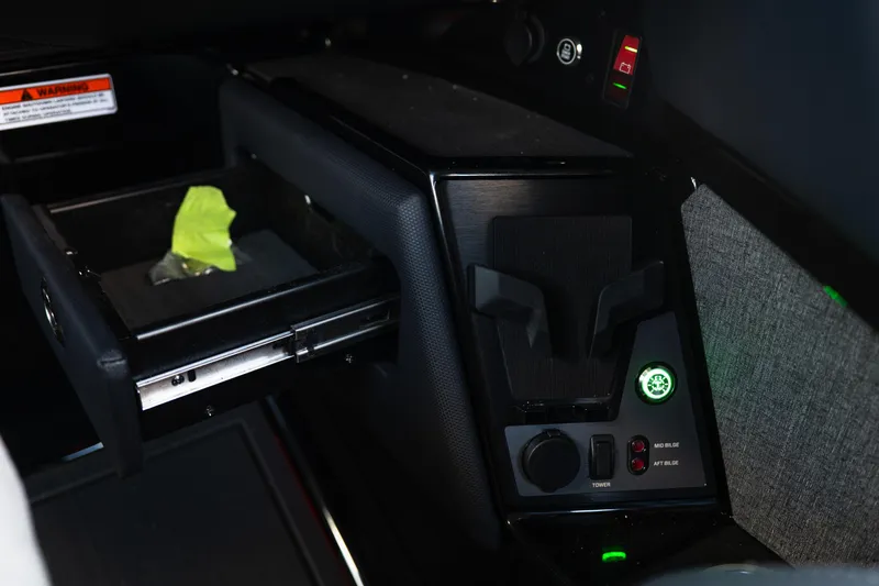 Slide: The Image of Interior console of 2026 MasterCraft XStar 25 boat with control panel and storage drawer. - 38