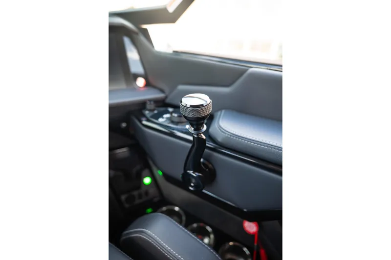 Slide: The Image of Interior view of 2026 MasterCraft XStar 25 boat, featuring sleek control lever design. - 39