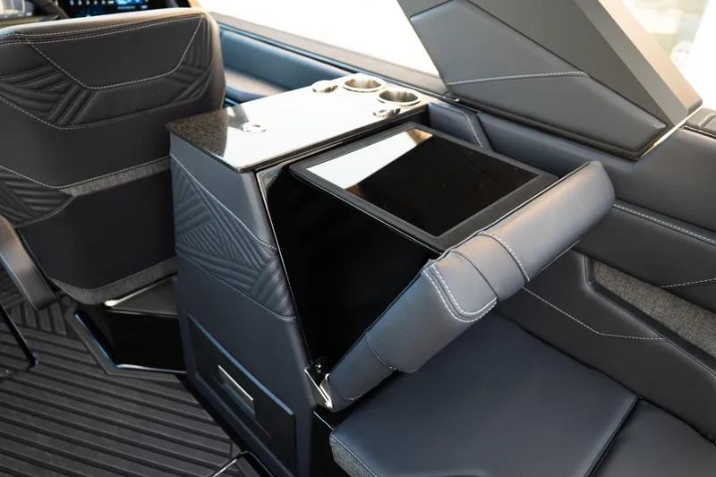 Slide: The Image of 2026 MasterCraft XStar 25 interior with sleek black seating and modern console design. - 45