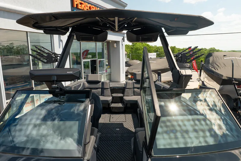 Slide: The Image of 2026 MasterCraft XStar 25 boat with sleek design and modern features at a dealership. - 51