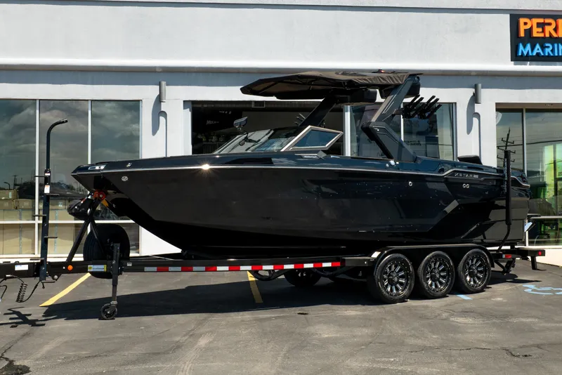 Slide: The Image of 2026 MasterCraft XStar 25 boat on trailer, parked outside dealership. - 6