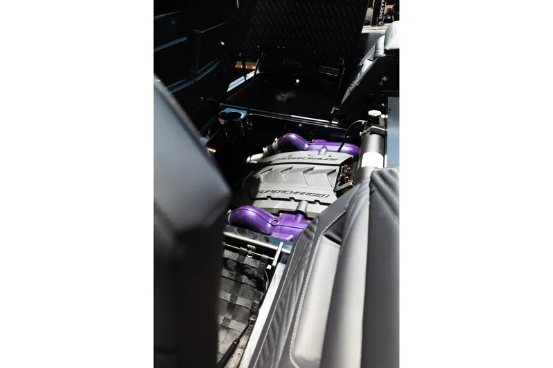 Slide: The Image of Engine compartment of 2026 MasterCraft XStar 25 boat, featuring a powerful supercharged engine. - 61