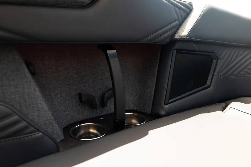 Slide: The Image of Interior of 2026 MasterCraft XStar 25 boat featuring cup holders and speaker. - 65