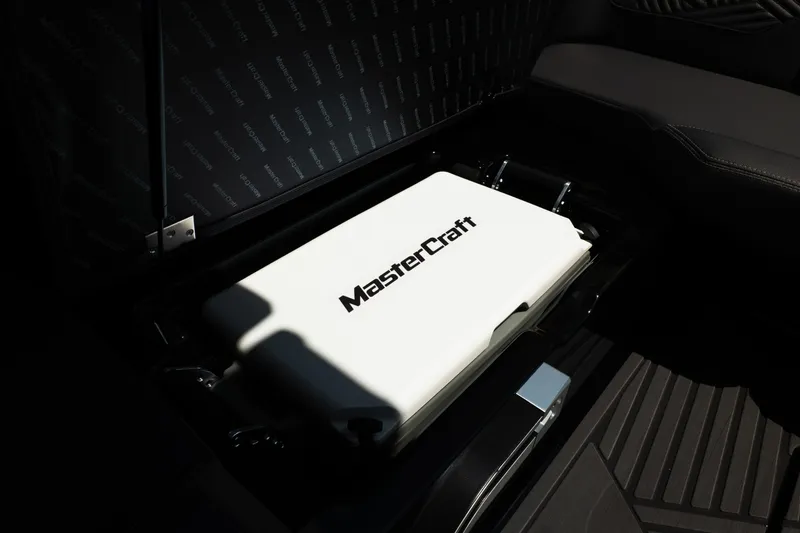 Slide: The Image of Interior of 2026 MasterCraft XStar 25 showcasing branded storage compartment. - 66
