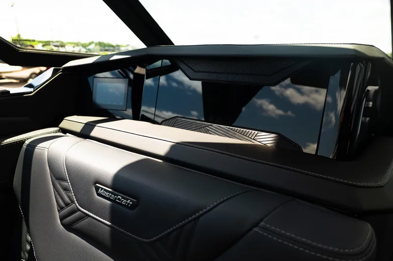 Slide: The Image of Interior view of 2026 MasterCraft XStar 25 boat, showcasing sleek dashboard design. - 67