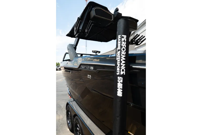 Slide: The Image of 2026 MasterCraft XStar 25 boat with sleek black design at Performance Marine Watersports. - 69