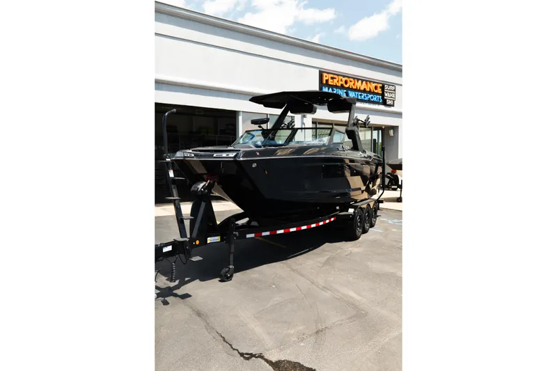 Slide: The Image of 2026 MasterCraft XStar 25 boat on trailer at Performance Marine Watersports dealership. - 70