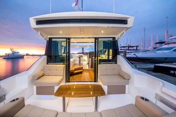 The Image of Manufacturer Provided Image: 2018 Tiara Yachts C44 Coupe luxury yacht interior at sunset, docked at marina. - 0