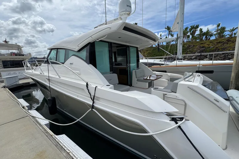 Slide: The Image of 2018 Tiara Yachts C44 Coupe docked, showcasing sleek design and spacious deck. - 10