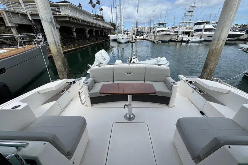 Slide: The Image of 2018 Tiara Yachts C44 Coupe in marina, featuring spacious seating and elegant design. - 14