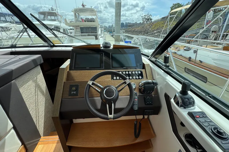 Slide: The Image of Helm of 2018 Tiara Yachts C44 Coupe with modern controls and navigation displays. - 19