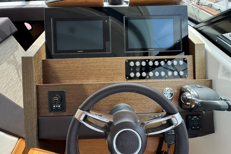 Slide: The Image of Helm of 2018 Tiara Yachts C44 Coupe with dual Garmin displays and controls. - 21