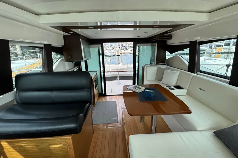 Slide: The Image of Interior of 2018 Tiara Yachts C44 Coupe with elegant seating and wooden table. - 23