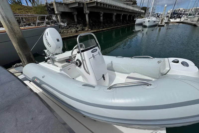 Slide: The Image of Inflatable boat docked beside a 2018 Tiara Yachts C44 Coupe in a marina. - 31