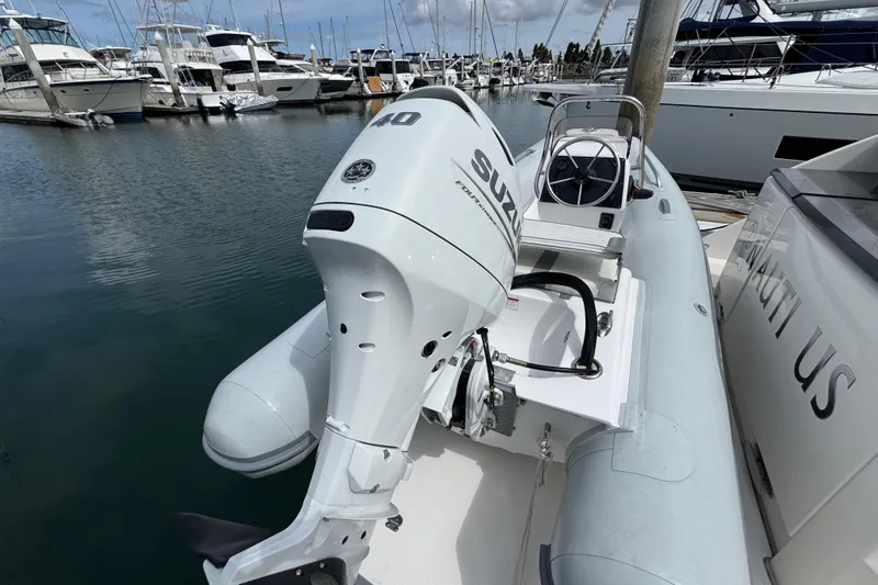 Slide: The Image of Inflatable boat with Suzuki outboard motor docked near Tiara Yachts C44 Coupe, 2018 model. - 33