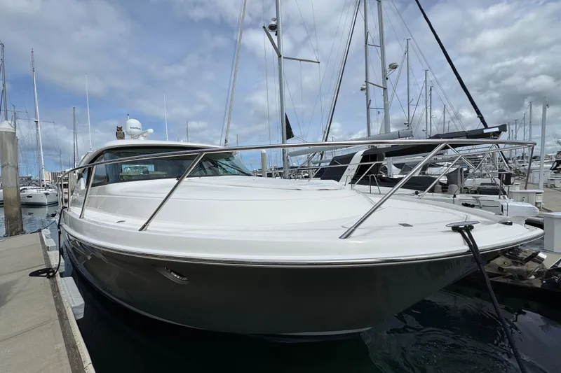 Slide: The Image of 2018 Tiara Yachts C44 Coupe docked at marina under cloudy sky. - 4