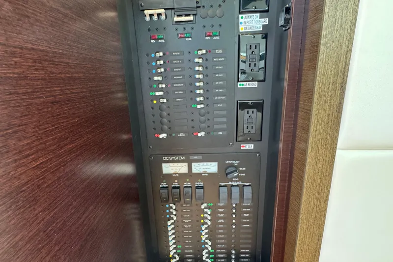 Slide: The Image of Electrical control panel on a 2018 Tiara Yachts C44 Coupe, featuring various switches and outlets. - 40
