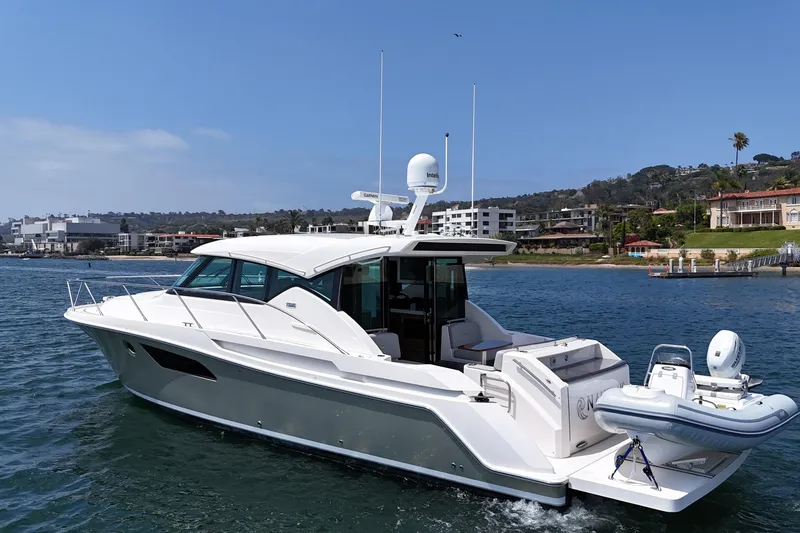 Slide: The Image of Manufacturer Provided Image: 2018 Tiara Yachts C44 Coupe luxury yacht interior at sunset, docked at marina. - 7