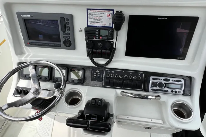 Slide: The Image of Console of 2008 Sailfish 2360 CC boat with steering wheel, electronics, and controls. - 10