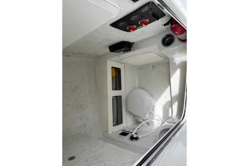 Slide: The Image of Interior of 2008 Sailfish 2360 CC boat, featuring storage and control panel. - 11