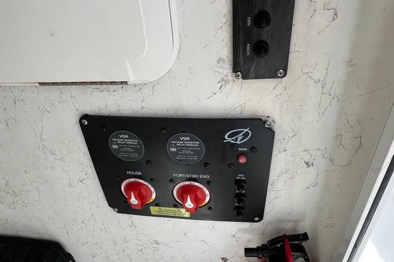 Slide: The Image of Control panel of a 2008 Sailfish 2360 CC boat with switches and dials. - 12