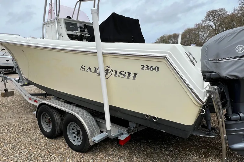 Slide: The Image of 2008 Sailfish 2360 CC boat on trailer, side view with outboard motor. - 2