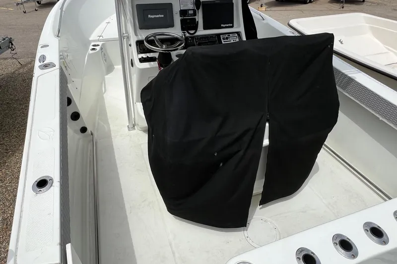 Slide: The Image of 2008 Sailfish 2360 CC boat interior with covered console and Raymarine electronics. - 7