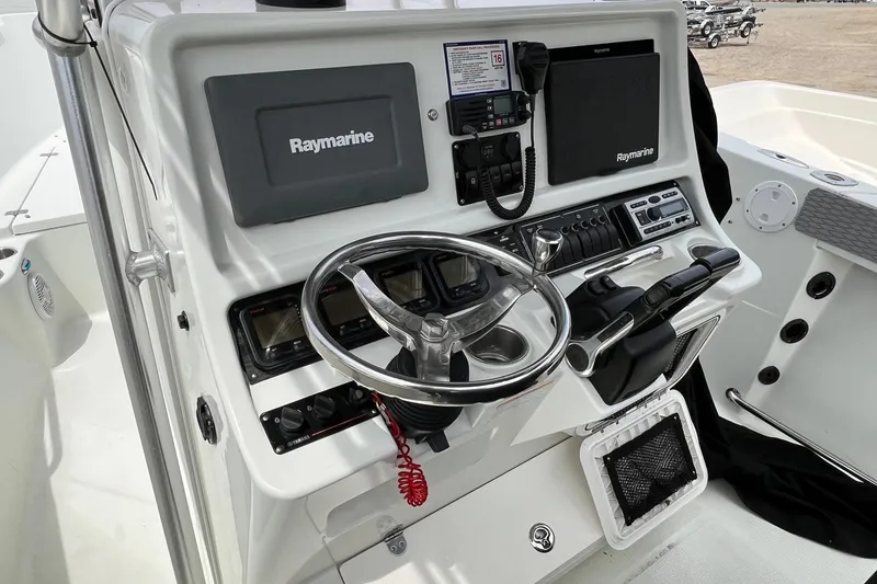 Slide: The Image of 2008 Sailfish 2360 CC boat console with Raymarine electronics and steering wheel. - 8