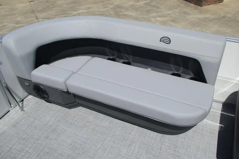 Slide: The Image of 2026 Sun Tracker Party Barge 16 DLX seating area with gray upholstery and cup holders. - 13