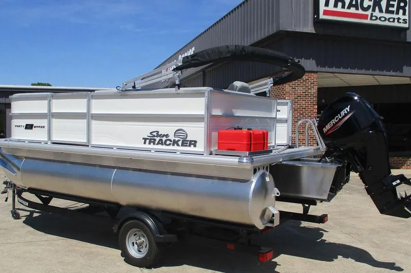 Slide: The Image of 2026 Sun Tracker Party Barge 16 DLX pontoon boat with Mercury engine at dealership. - 3