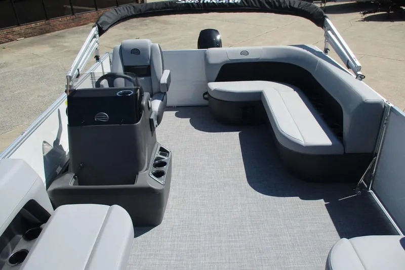 Slide: The Image of 2026 Sun Tracker Party Barge 16 DLX interior with gray seating and helm station. - 5