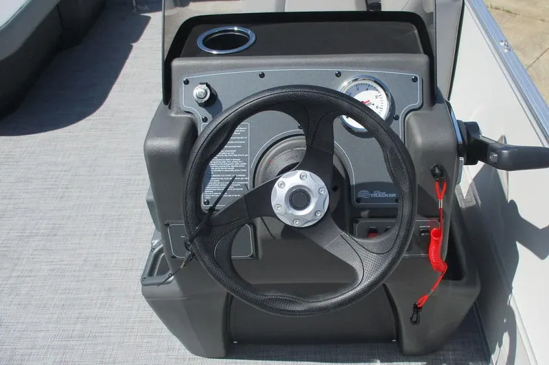 Slide: The Image of Steering console of 2026 Sun Tracker Party Barge 16 DLX with cup holder and controls. - 6