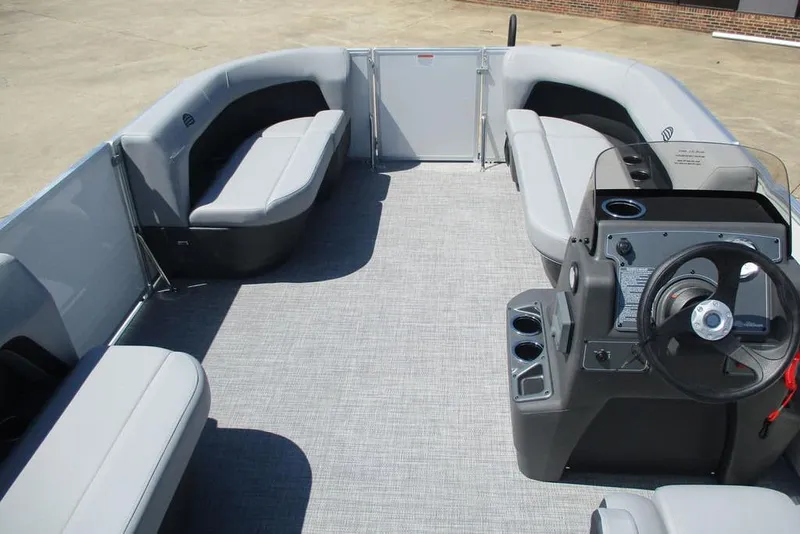 Slide: The Image of 2026 Sun Tracker Party Barge 16 DLX interior with seating and steering console. - 8
