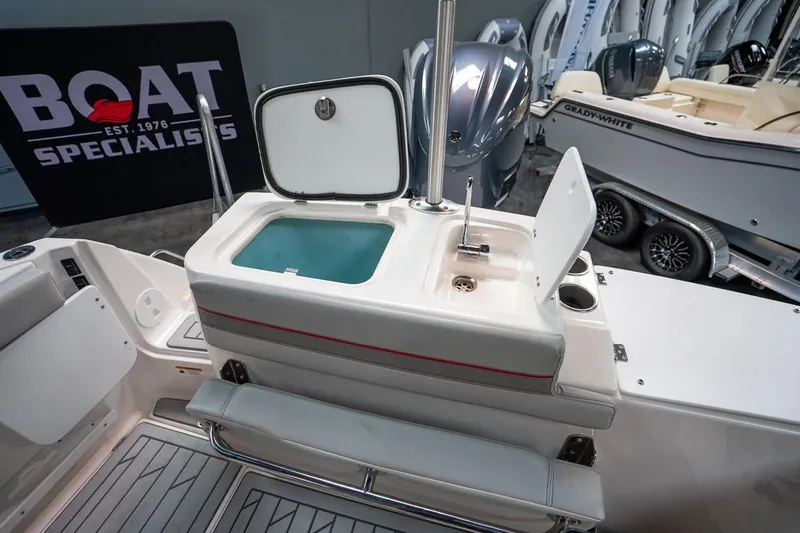 Slide: The Image of 2024 Solara S250 Dual Console boat interior with sink and storage compartment. - 12
