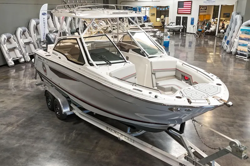 Slide: The Image of 2024 Solara S250 Dual Console boat displayed indoors on a trailer. - 3