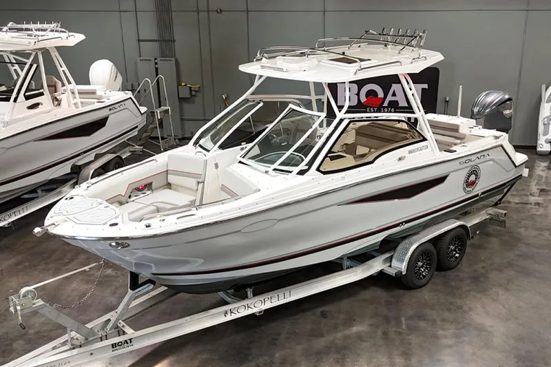 Slide: The Image of 2024 Solara S250 Dual Console boat on trailer in showroom setting. - 4