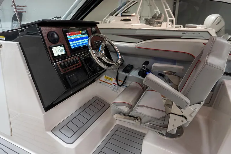 Slide: The Image of 2024 Solara S250 Dual Console boat interior with modern dashboard and comfortable seating. - 7