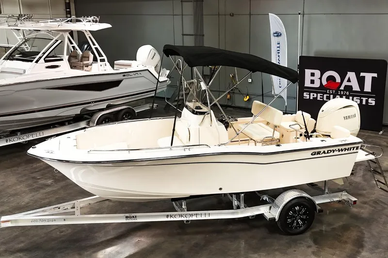 The Image of 2025 Grady-White Fisherman 180 boat on trailer, displayed indoors with Yamaha engine. - 1