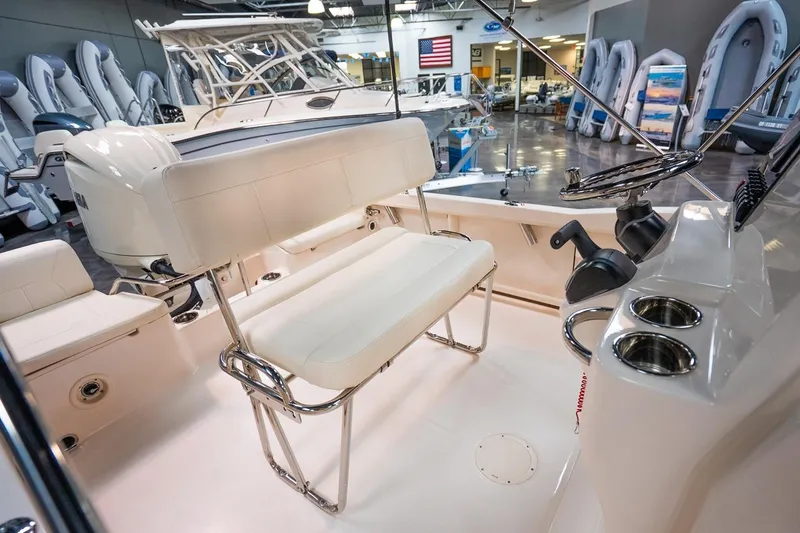 Slide: The Image of 2025 Grady-White Fisherman 180 boat interior with seating and steering console in showroom. - 3