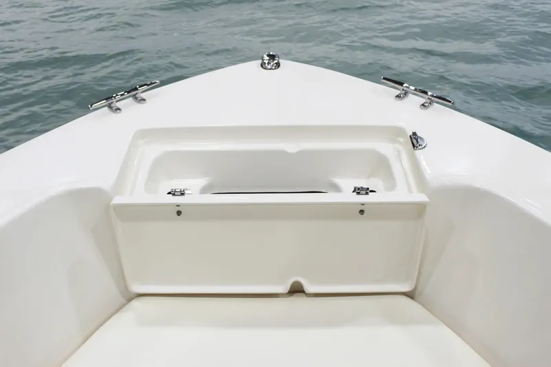 Slide: The Image of Bow storage compartment on 2025 Grady-White Fisherman 180 boat, open on calm water. - 7