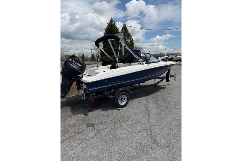 Slide: The Image of 2017 Bayliner 160 Bowrider boat on trailer, featuring a Mercury outboard motor. - 11