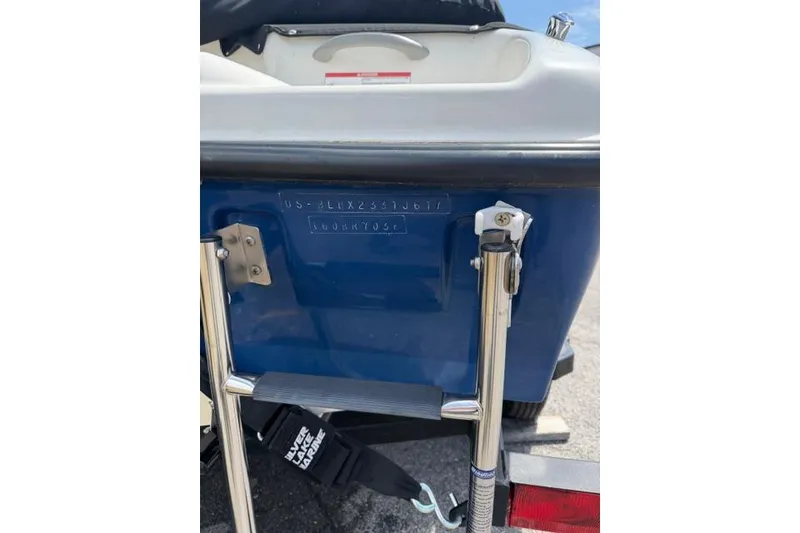 Slide: The Image of 2017 Bayliner 160 Bowrider boat stern with ladder and identification number. - 15
