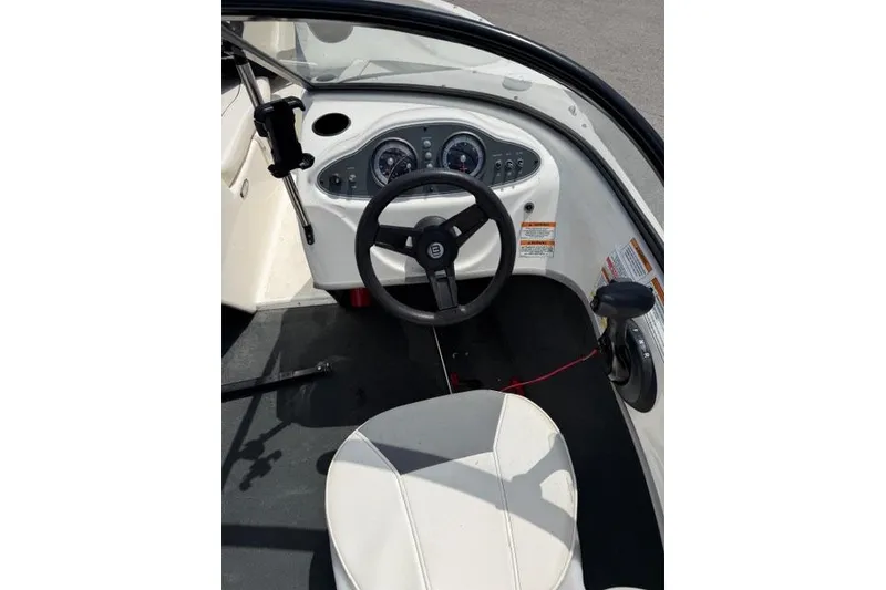 Slide: The Image of 2017 Bayliner 160 Bowrider cockpit with steering wheel and dashboard controls. - 4
