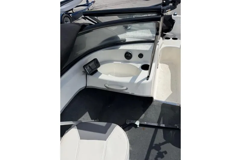 Slide: The Image of 2017 Bayliner 160 Bowrider interior with seating and dashboard view. - 5