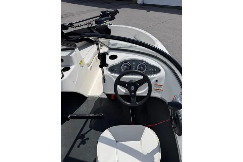 Slide: The Image of 2017 Bayliner 160 Bowrider boat interior with steering wheel and dashboard controls. - 8